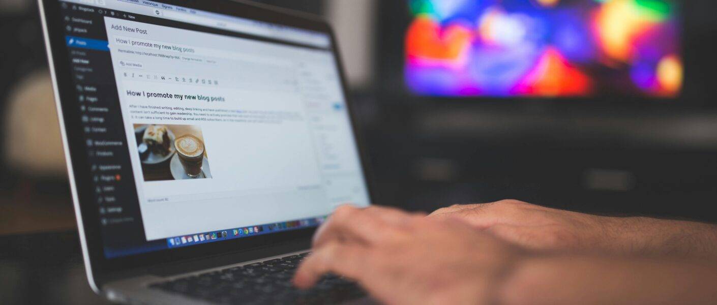 blogger typing on computer