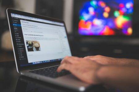 blogger typing on computer