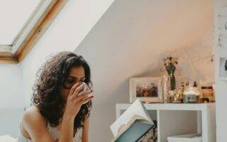 woman in bed reading a book