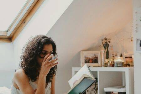 woman in bed reading a book