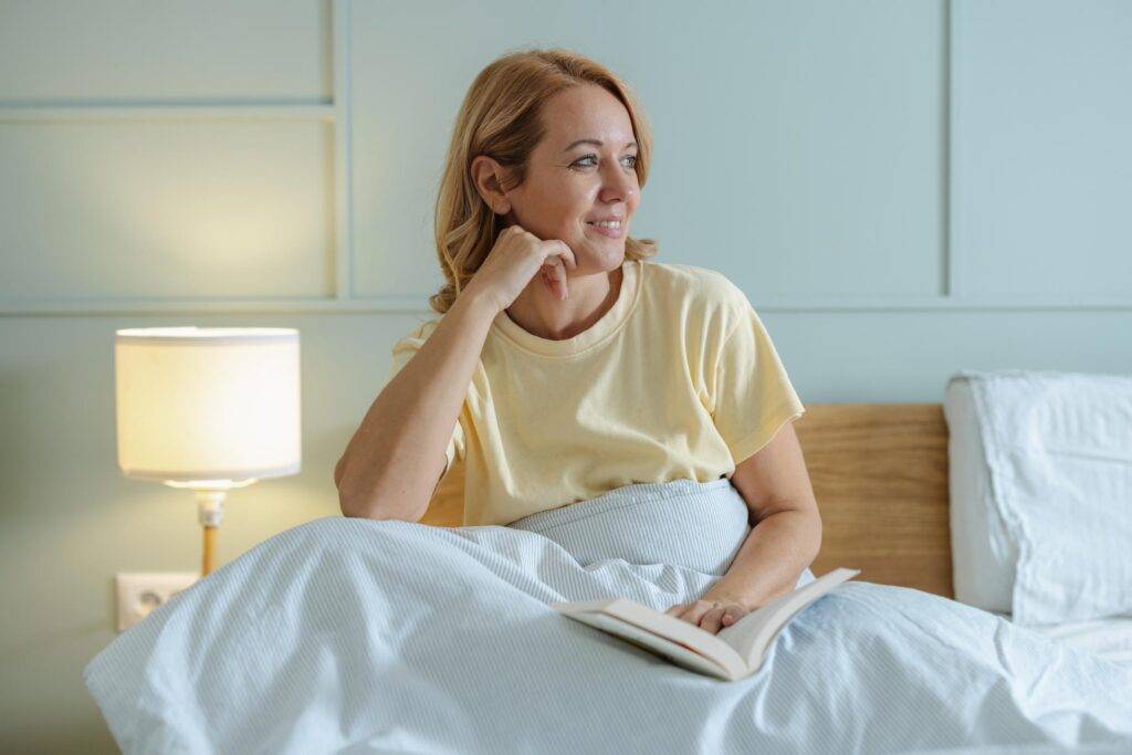woman in bed reading improving sleep GLP-1 weight loss experience nighttime routine
